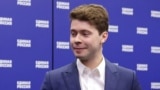Ilya Medvedev, son of former Russian President Dmitry Medvedev, stands in front of a backdrop bearing the name of the ruling United Russia party.