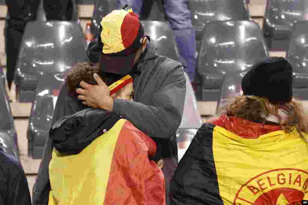Egy szurkolót vigasztalnak a stadion lelátóján 2023. október 16-án, hétfőn. Belgium az elmúlt években több iszlamista támadás célpontja volt, a leghalálosabb a 2016-os, a brüsszeli repülőtér és a város metrója elleni, amelyben harminckét ember halt meg. A 2015-ös, százharminc halálos áldozatot követelő párizsi merényletet elkövető iszlamista fegyveresek közül többen belgák voltak vagy Brüsszelben éltek