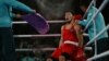 A Kazakh boxer catches his breath between rounds at a match during the Paris Olympics.