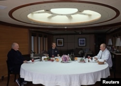 Lukashenka (left) and his son Mikalay (center) dine at sea with Putin aboard the Chaika.