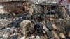 Investigators work at the site of a residential a building damaged during a Russian drone strike in the village of Stari Bezradychi in the Kyiv region on December 19.