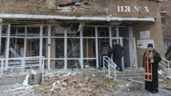 A priest stands in front of a hospital destroyed after shelling between Ukrainian forces and pro-Russian separatists in the eastern city of Donetsk, Ukraine, on January 19.