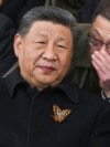 Russian President Vladimir Putin and Chinese leader Xi Jinping talk as they watch the Victory Day military parade in Moscow in May 2025. 