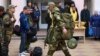 Mobilized men are seen at a gathering station set up in a cultural center in the town of Bataisk in southwestern Russia.