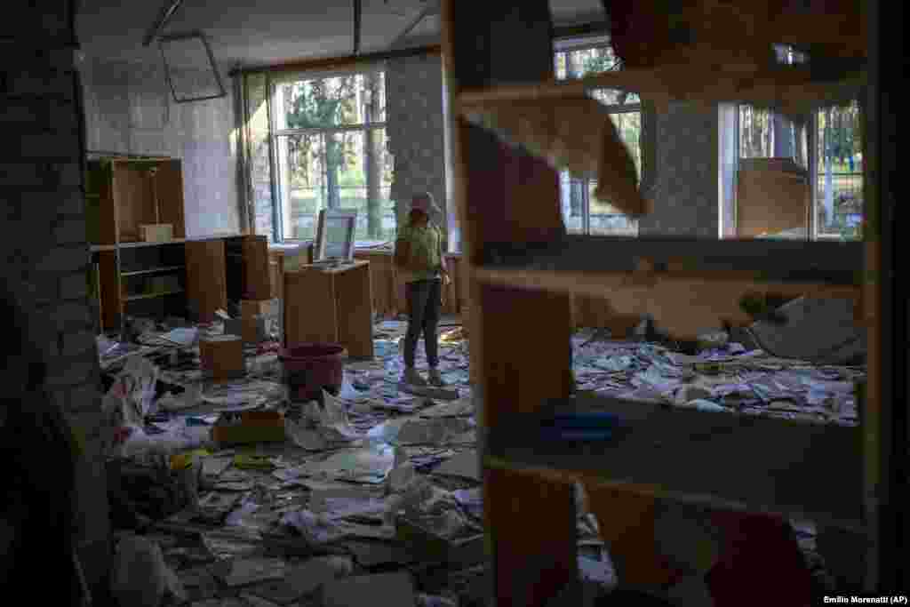 "When my school was bombed, I was terrified. We live nearby. Our windows were damaged, and my mother could have died because the door almost pressed her to the wall. And the chandelier almost fell on me," said Karina Muzyka, 10, who visits the shattered school every day to play with her friends.