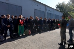Russian recruits stand near a military recruitment center in Krasnodar, Russia, on September 25, 2022.