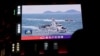 A China Coast Guard vessel is seen on a giant screen showing news footage about the coast guard's patrols in waters around Taiwan on April 1. 