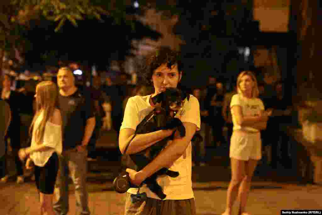 Residents gather after the attack. Two women have been reported dead after the latest wave of Russian strikes on Kyiv.