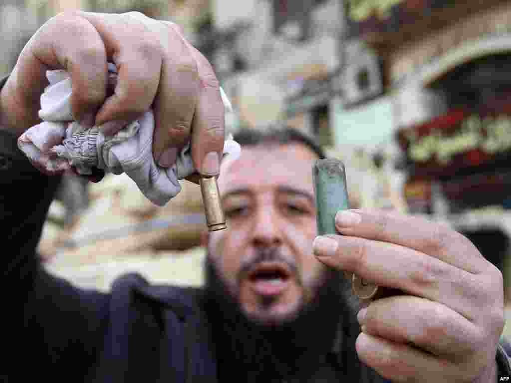 A man displays empty bullet casings in Cairo’s central al-Tahrir square on January 29.