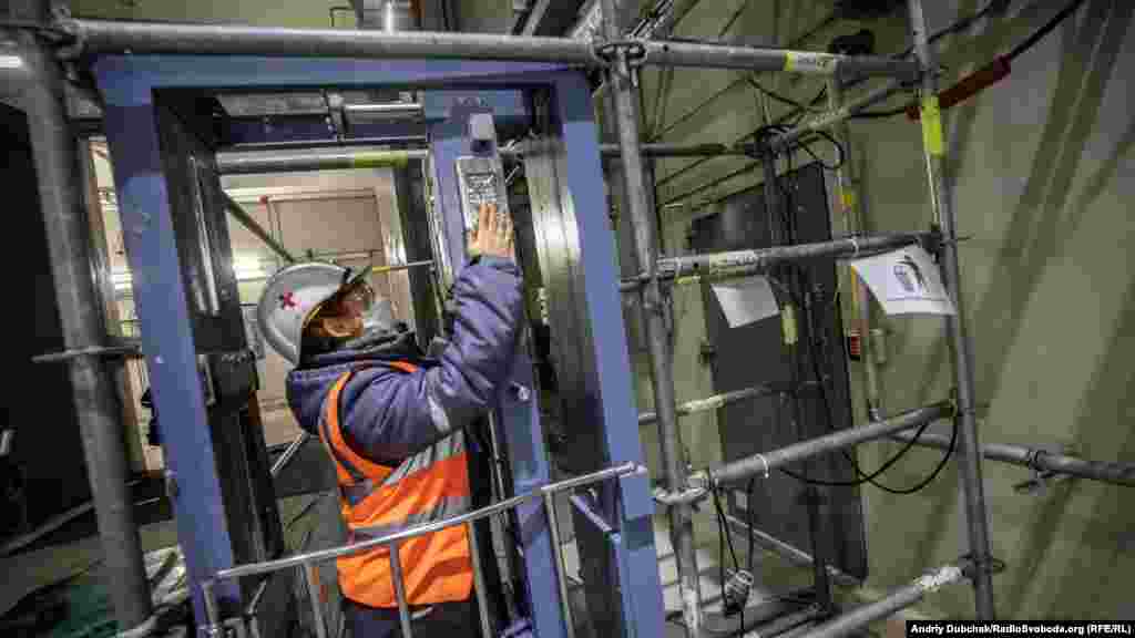 In order to move around Chernobyl's containment structure, workers must routinely check if they have been exposed to radiation. This worker tests radiation levels with monitoring equipment known as a dosimetric control system.