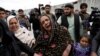 An Afghan Sikh woman mourns for her relatives near the site of an attack in Kabul on March 25.