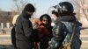Патрульные полицейские проверяют прохожих. Город Жанаозен Мангистауской области, 19 декабря 2011 года. 