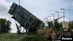 Ukrainian service members walk next to a launcher of a Patriot air defence system an undisclosed location in Ukraine.