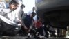 Pakistani investigators look at the belongings of attackers including grenades outside the Chinese consulate after an attack in Karachi on November 23.