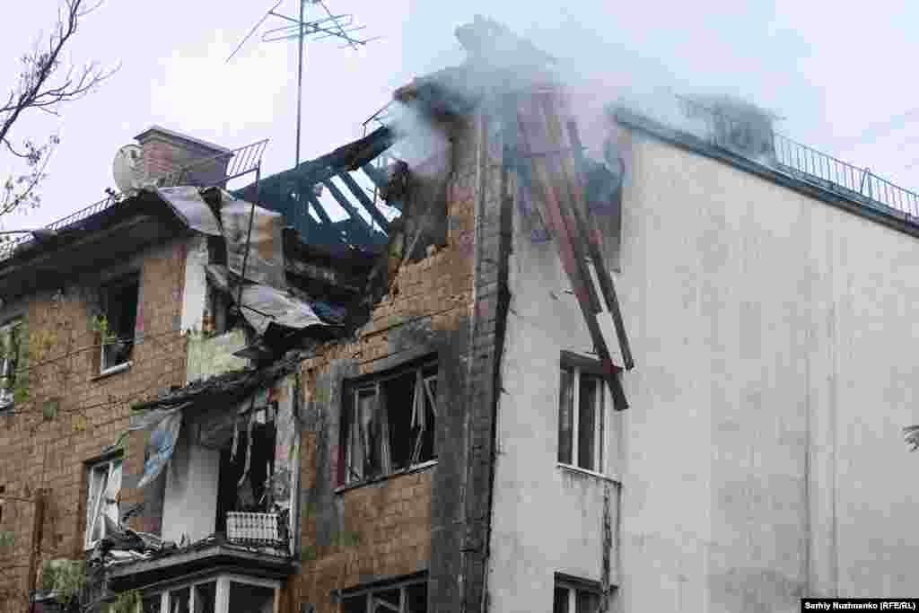An apartment smoulders in Kyiv after taking a direct hit from a missile or drone on July 10.
