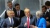 NATO Secretary General Jens Stoltenberg, left, US President Donald Trump and Britain's Prime Minister Theresa May, right, talk during a family picture ahead of the opening ceremony of the NATO summit on July 11.