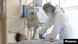 Armenia -- A healthcare worker in protective gear tends to a COVID-19 patient at the Surp Grigor Lusavorich Medical Center, Yerevan, June 5, 2020.