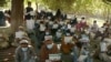 Afghans wait to receive cash from a counter in Nangarhar Province on November 8. Kabul will see cuts in donations at a time the World Bank estimates the Afghan economy will contract by at least 5.5 percent this year because of COVID-19 impacts. 