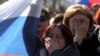 Люди слушают выступление президента России Владимира Путина в центре города Севастополь. 18 марта 2014 года.