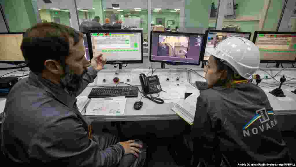 Two nuclear containment specialists inside the main control center at the New Safe Confinement (NSC). Some 3,000 people work at the site, including several foreign specialists. 