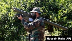 A Hizballah fighter in Lebanon holds an Iranian-made antiaircraft missile on the border with Israel. (file photo)