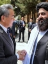Taliban Foreign Minister Amir Khan Muttaqi welcomes Chinese Foreign Minister Wang Yi to Kabul ahead of a August 20 trilateral meeting with Pakistan. 