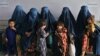 Afghan women wait during the visit of UN High Commissioner for Refugees Filippo Grandi at the Azakhel Voluntary Repatriation Center in Khyber Pakhtunkhwa Province on September 9.