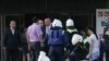 Russia -- Russian Emergency Ministry servicemen help an injured woman aftern explosion in Stavropol, 26May2010