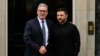 Britain's Prime Minister Keir Starmer (left) shakes hands with Ukrainian President Volodymyr Zelenskyy as he greets him on the steps of 10 Downing Street in central London on August 14.