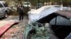 A damaged car in the aftermath of a rocket attack in downtown Kabul on August 18