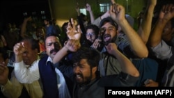 Supporters of former Pakistani Prime Minister Nawaz Sharif shout slogans during his arrival from jail at the cardiac center at the Pakistan Institute of Medical Sciences in Islamabad on July 29.