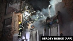 Rescuers extinguish a fire in an apartment building destroyed by a Russian missile attack in Kharkiv early on May 31 amid the Russian invasion in Ukraine.