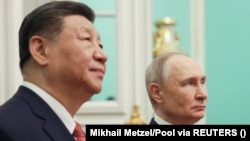 Russian President Vladimir Putin (right) and Chinese President Xi Jinping meet in Moscow in May.