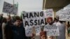 Supporters of Tehreek-e Labaik Pakistan, a hardline religious political party hold placards as they march during a protest in Rawalpindi on October 12.