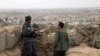 FILE: Afghan police officers keep watch at their forward base on the outskirts of Kunduz Province.