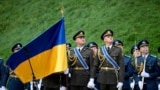 Ukrainian Honor Guard soldiers march during a ceremony for National Flag Day in Kyiv on August 23. 