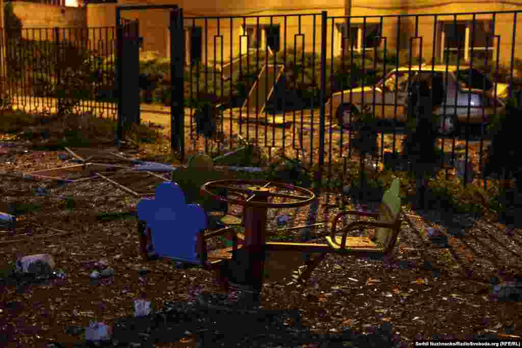 Debris is seen in a playground after an explosion rocked an apartment building during the wave of Russian strikes.