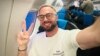 Belarusian activist Andrey Hnyot celebrates during his flight out of Serbia on October 31.