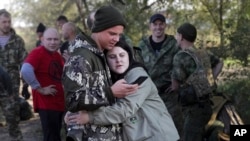 A Russian recruit and his wife embrace at a railway station in Prudboi, in Russia's Volgograd region, in September 2022 after President Vladimir Putin announced a partial mobilization.