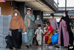 Families evacuated from Kabul arrive in Washington, D.C., in September 2021.