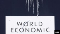 Switzerland -- Icicles hang over the World Economic Forum's logo in Davos, 26Jan2009