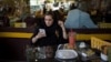 An Iranian woman uses her mobile phone in a coffee shop in Tehran. (file photo)