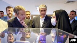 The head of the International Atomic Energy Agency, Rafael Grossi (left), visits the headquarters of Iran's Atomic Energy Organization in Tehran in April.