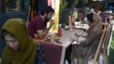 In this picture taken on August 5, 2019, a couple enjoys their meal in a cafe in Kabul, Afghanistan.