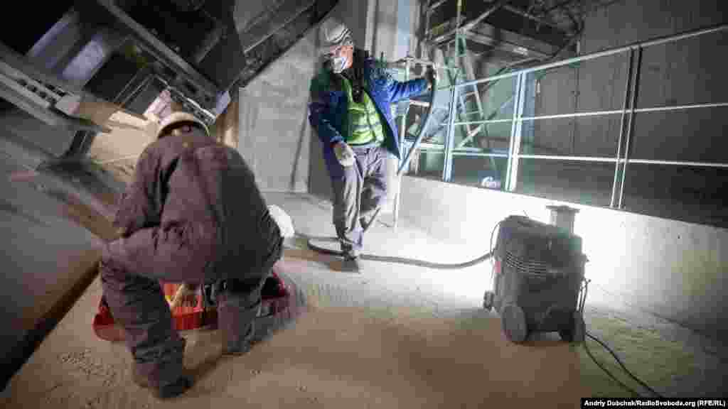 Workers inside the New Safe Confinement (NSC) grind joints of the concrete pillars. Although there can be a lot of dust inside the shield, the level of the radioactivity is relatively low. Officials say there is little risk to the health of the workers. 