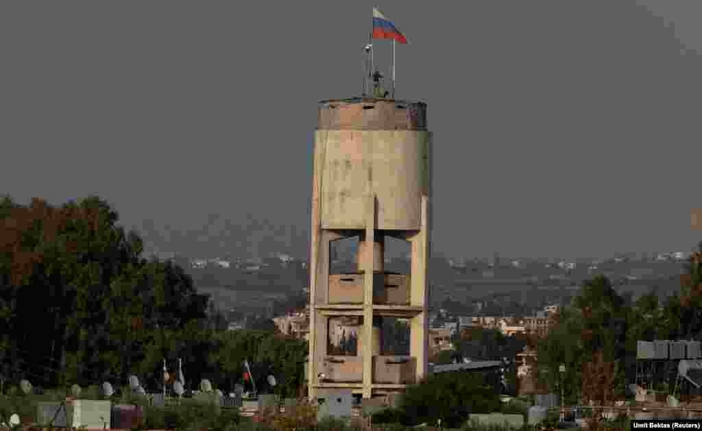 Russian servicemen install what appears to be a camera system atop a water tower inside the Hmeimim base. As well as this apparent CCTV system, which Bektas captured being built, he says there's also "an eye-in-the-sky surveillance system, like a zeppelin on top of the air base for watching around."