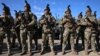 Moldovan soldiers line up next to military vehicles received by the United States at a ceremony in Chisinau, Moldova, on February 18. On April 9, the EU is set to green-light the bloc's largest-ever military aid package to the country, which borders Ukraine.