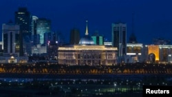 The Akorda (center, with blue dome and golden spire), the official residence of the president, stands out at night amid Astana's skyline.