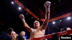 Oleksandr Usyk celebrates winning his fight against Daniel Dubois in London on July 19. 