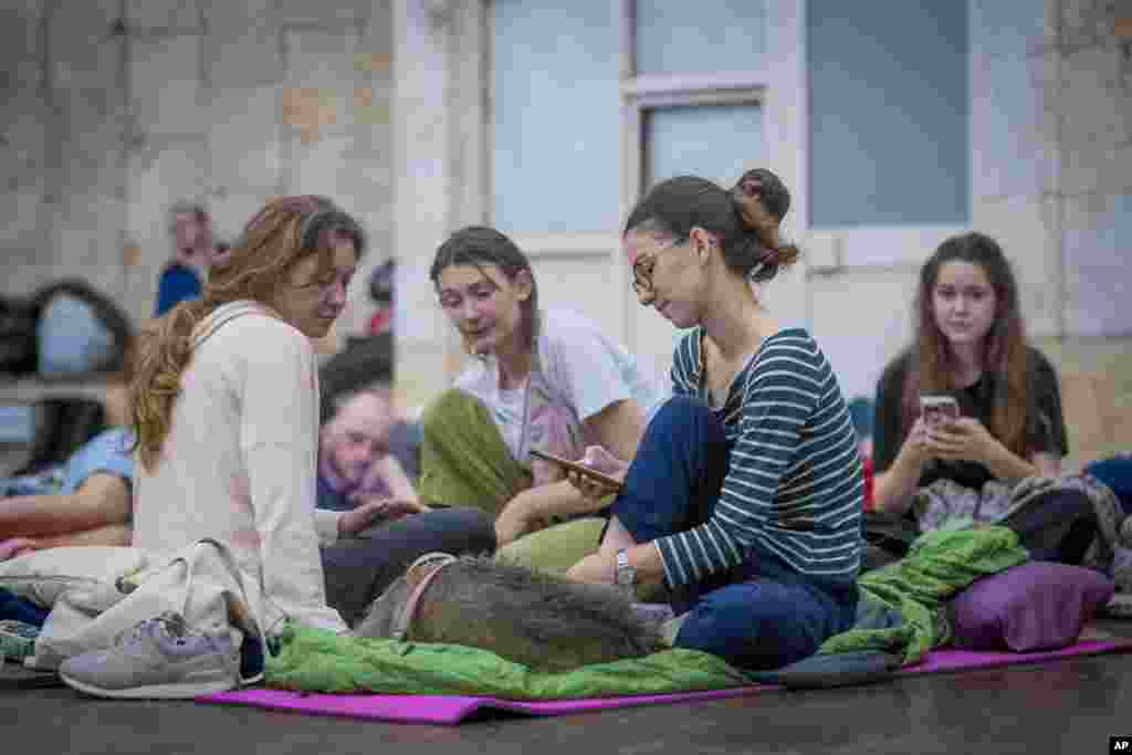 People shelter in a Kyiv subway station during a Russian rocket attack on the Ukrainian capital.